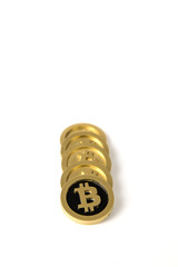 Golden coins with the bitcoin symbol on white