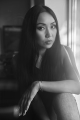 Model sits on a window sill against a gray wall