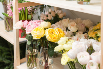 Flower shop concept. Different varieties fresh spring flowers in refrigerator room for flowers. Bouquets on shelf, florist business.