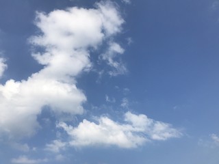 Obraz premium Clouds at the left in a blue sky
