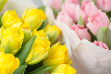 Tuips closeup. Flower shop concept. Mixed color. Fresh spring flowers in refrigerator room for flowers. Bouquets on shelf, florist business.
