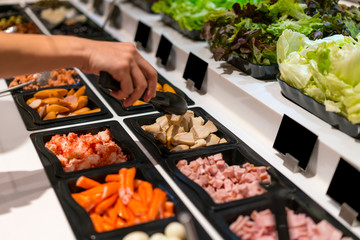 woman hands holding tweezer and ham salad