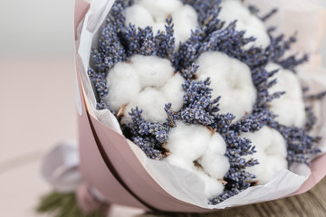 beautiful bouquet lavender and cotton, on table . dried flowers white and lilac color