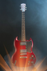 Fototapeta na wymiar electric guitar in smoke with shiny glare