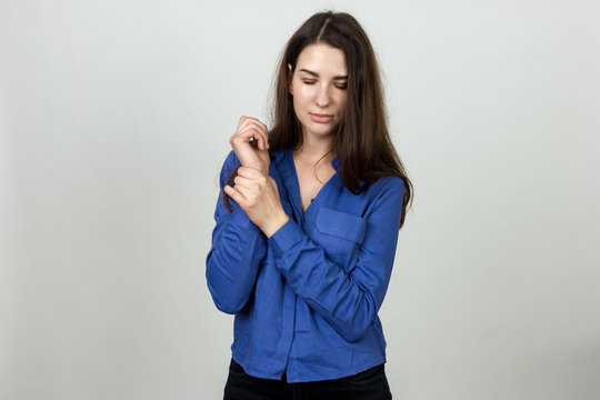 Woman Holding Sore Wrist In Her Hand