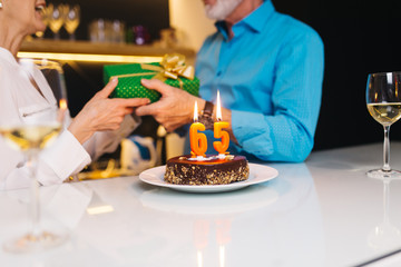 Happy senior couple celebrating man's birthday.