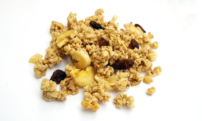 A handful of crunchy granola, muesli  with dried fruit on white background