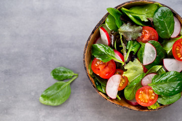 Fresh salad with baby spinach and tomato, radish und salad.