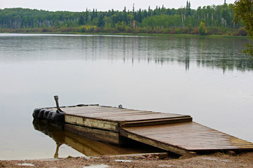 A boat dock at a quiet summer lake