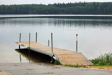 A boat dock along side a freshwater lake