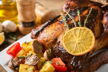 Delicious whole roasted chicken served on plate