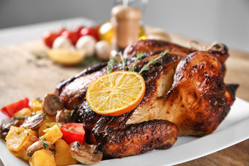 Delicious whole roasted chicken served on plate