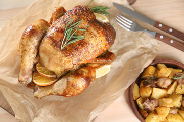 Delicious whole roasted chicken served on table
