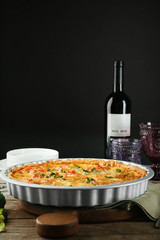 Tasty broccoli quiche served with wine on table