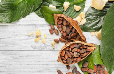 Composition with cocoa pod and beans on wooden table