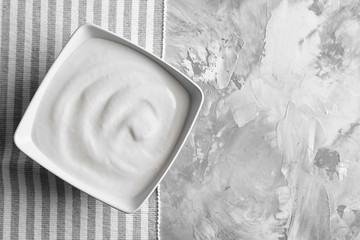 Tasty yogurt in dish on table