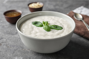 Tasty yogurt in dish on table