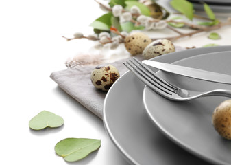 Beautiful festive Easter table setting with eggs on white background, closeup