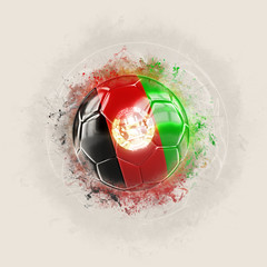 Grunge football with flag of afghanistan