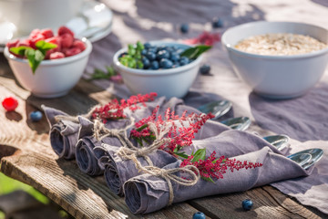 Fresh breakfast with raspberries and blueberries in garden