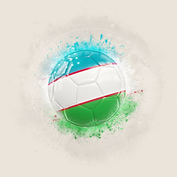 Grunge football with flag of uzbekistan