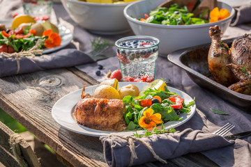 Healthy dinner with salad and chicken served in the countryside