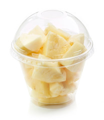 fresh pineapple pieces salad in plastic cup