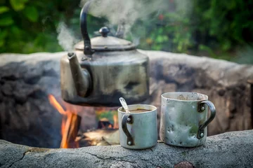 Zelfklevend Fotobehang Hot and aromatic coffee with kettle on campfire © shaiith