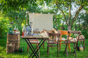 Open-air cinema with retro projector in the evening