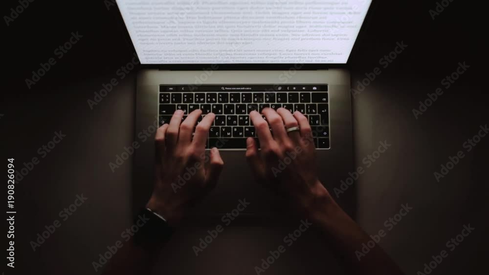 Poster man is working typing use laptop computer at home office at dark night. writer flat lay top view wor