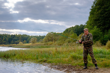 Fisherman with rod fishing