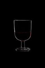 A low glass with red wine.