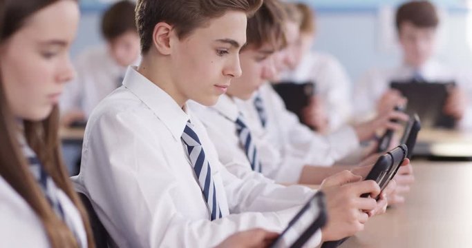 4k, Teenagers using digital tablets classroom. Slow motion.