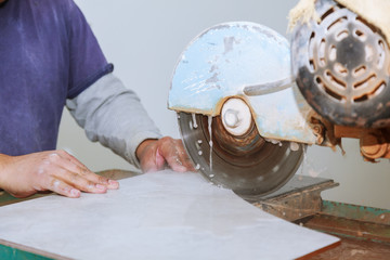 Tile being cut on a wet saw for that perfect fit.