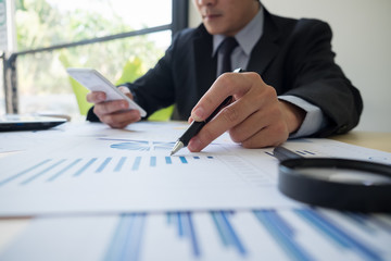 Business people meeting working with smartphone new startup project use post it notes to share idea discussion and analysis data charts and graphs.Business finances and accounting concept