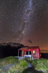 Stars and the Milky Way Galaxy are visible above a hut in the Matukituki Valley, Mt. Aspiring...