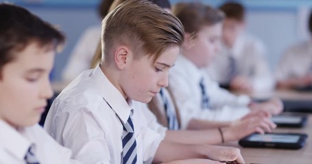 4k, Row of private high school students work on assignment in class.Slow motion.