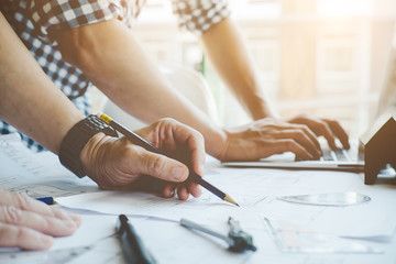 Architect or engineer working in office with blueprints,engineer inspection in workplace for...