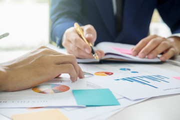 Asian business adviser meeting to analyze and discuss the situation on the marketing data online in the meeting room.Business finances and accounting