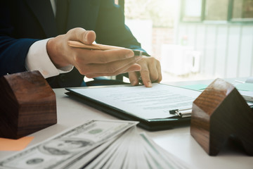 Close up of business person hand putting signing contract,running own small business,have a contract in place to protect it,signing of modest agreements form In office