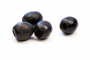 Four Black Olives on a White Background