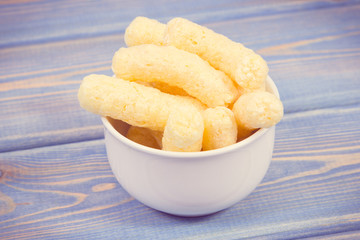 Vintage photo, Heap of crunchy corn snacks in bowl