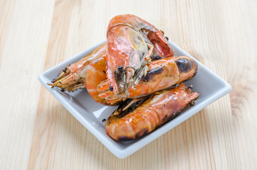 Thai style barbecue, grilled shrimp on wooden background