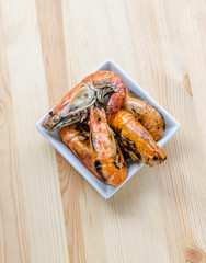 Thai style barbecue, grilled shrimp on wooden background