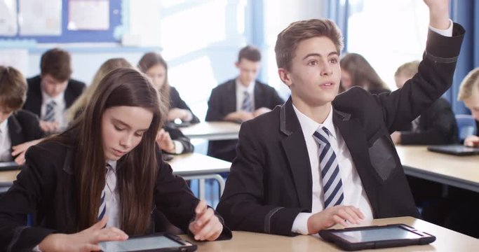 4k, High school pupils using tablet pcs in classroom. Slow motion.