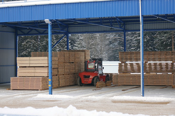 Fototapeta na wymiar machine is lifting lumber on a wood factory