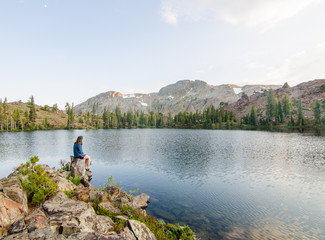 Fototapeta na wymiar Girl Sitting Looking at Lake