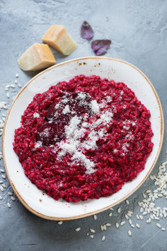 Risotto with beetroot and grated parmesan cheese, selective focus, vertical shot