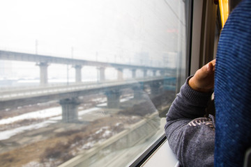 Obraz premium hand in Window train with in winter/ in white tones