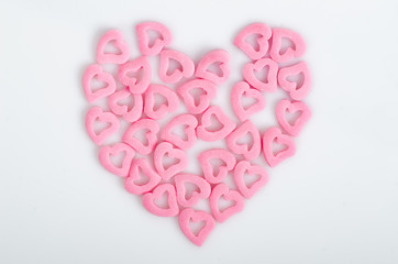 Sugar sprinkles heart shape, ornament for pie and bakery products, pink heart on white isolated background